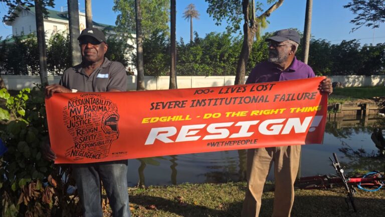 OGGN Member Frederick Collins holding up an MV Barima Banner